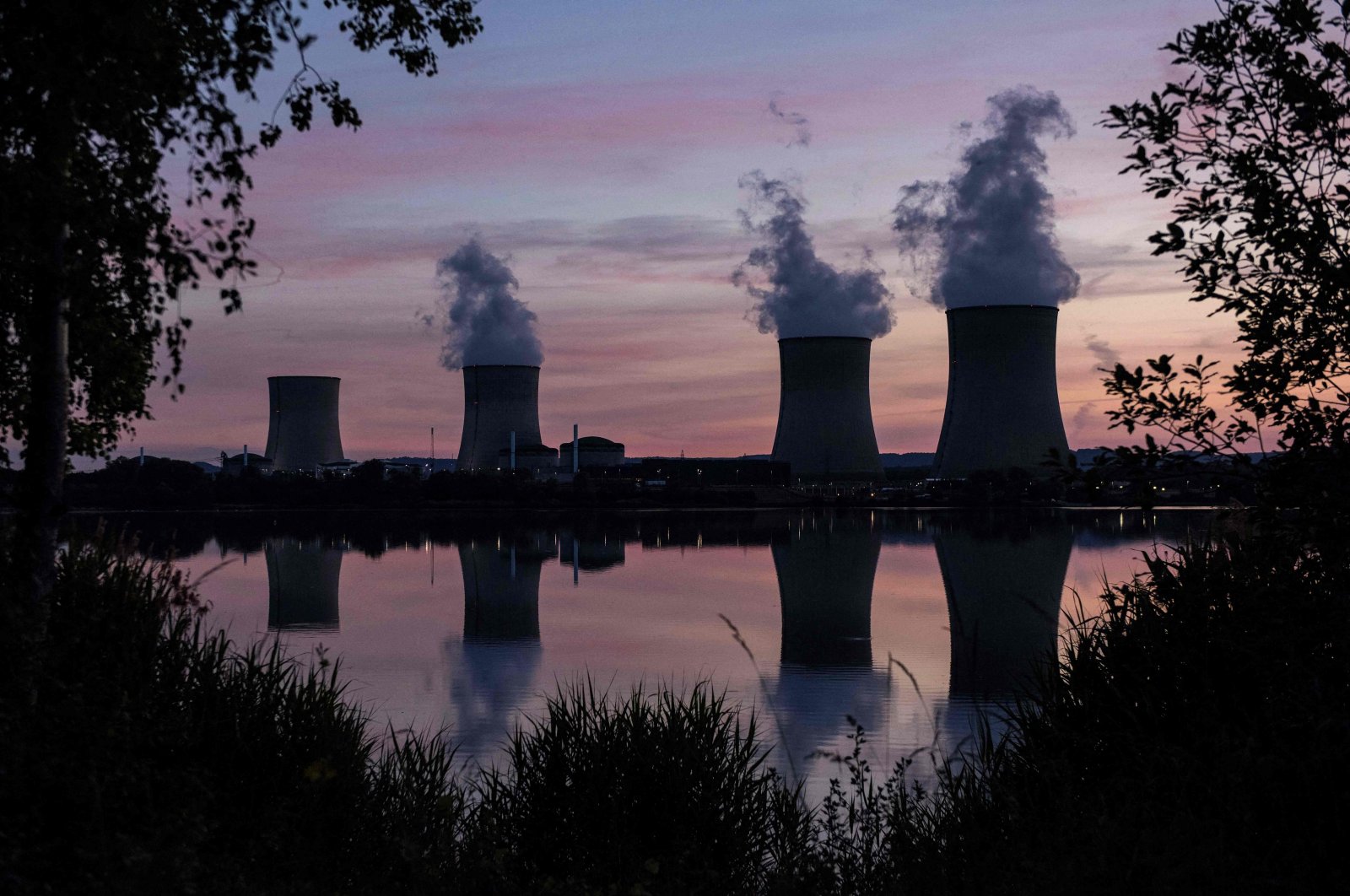 White steam billows from the Cattenom nuclear power plant at sunset in Cattenom, eastern France, June 2, 2020. (AFP Photo)