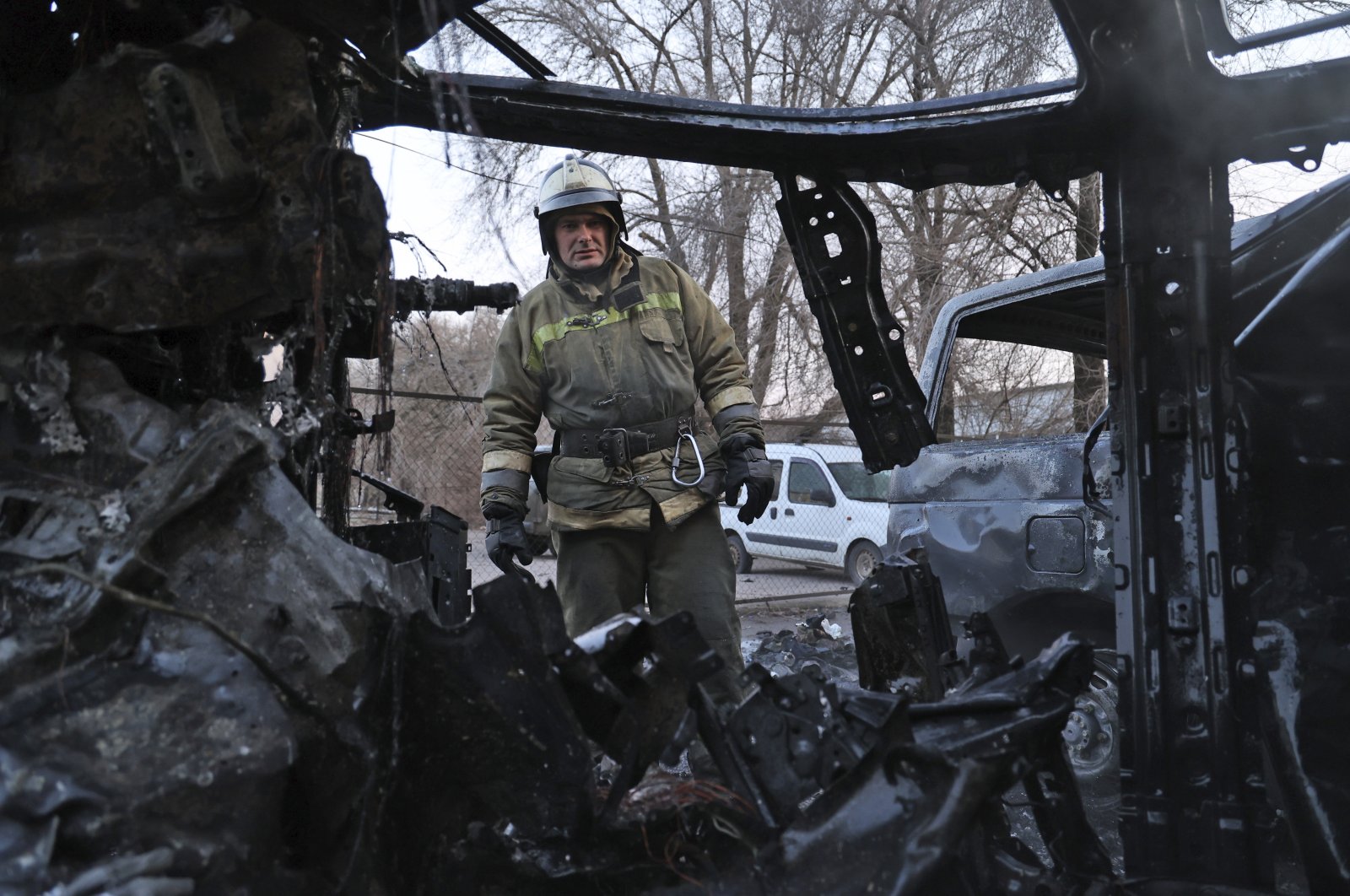 A firefighter examines a burned car after what Russian officials in Donetsk said was a shelling by Ukrainian forces, in Donetsk, eastern Ukraine, Dec. 15, 2022. (AP Photo)