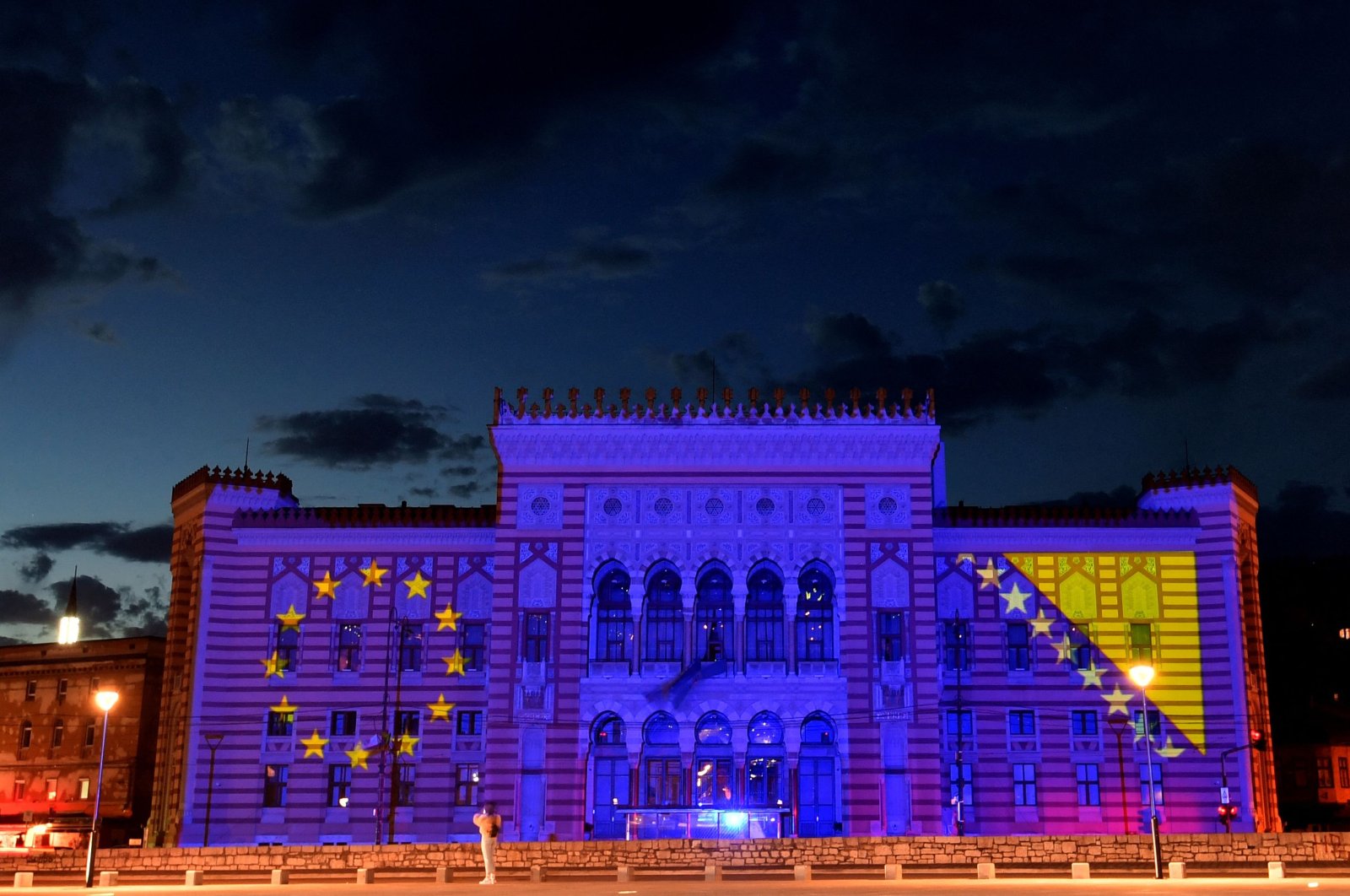 In this file photo taken on May 9, 2020, flags of the European Union and Bosnia-Herzegovina are projected on the facade of Sarajevo City Hall during an event to mark Europe Day. (AFP Photo)