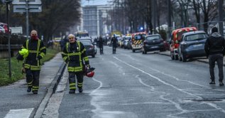 Firefighters walk in the Mas-Du-Taureau neighborhood where a fire killed at least 10 people, Vaulx-en-Velin, Lyon, France, Dec. 16, 2022. (AFP Photo)