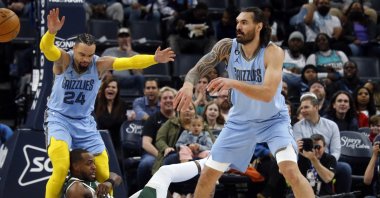 Milwaukee Bucks forward Khris Middleton holds onto the leg of Memphis Grizzlies forward Dillon Brooks after having the ball stolen by Memphis Grizzlies center Steven Adams during the first half at FedExForum, Memphis, Tennessee, U.S., Dec. 15, 2022. (Reuters Photo)
