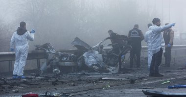 Forensic experts examine the site after a bomb exploded in a roadside vehicle while a police minibus passed by, in Diyarbakır, Türkiye, Dec. 16, 2022. (Reuters Photo)