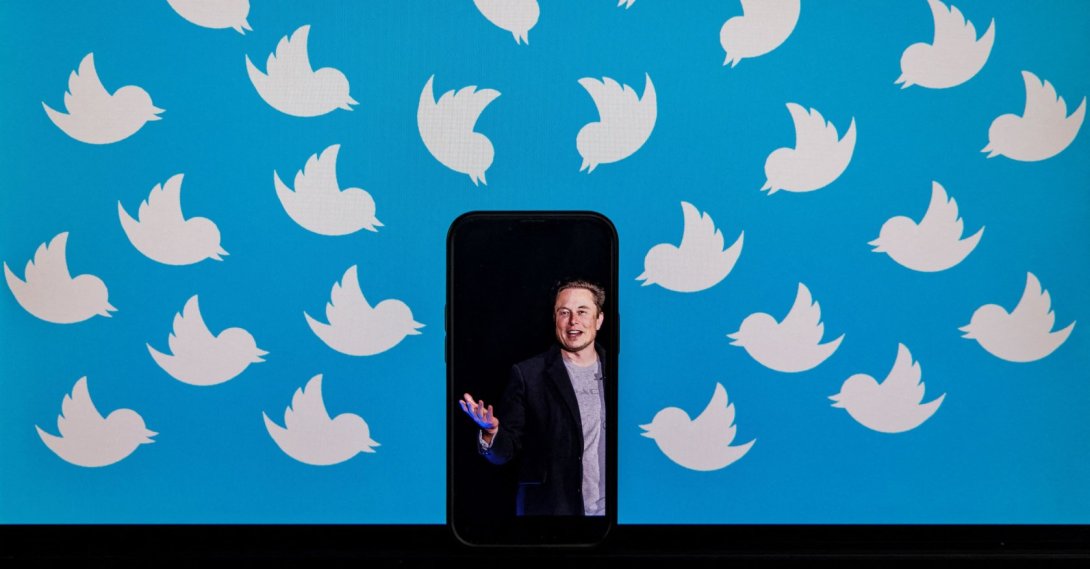 This file photo illustration shows a cellphone displaying a photo of Elon Musk placed on a computer monitor filled with Twitter logos in Washington, U.S., Aug. 5, 2022. (AFP Photo)