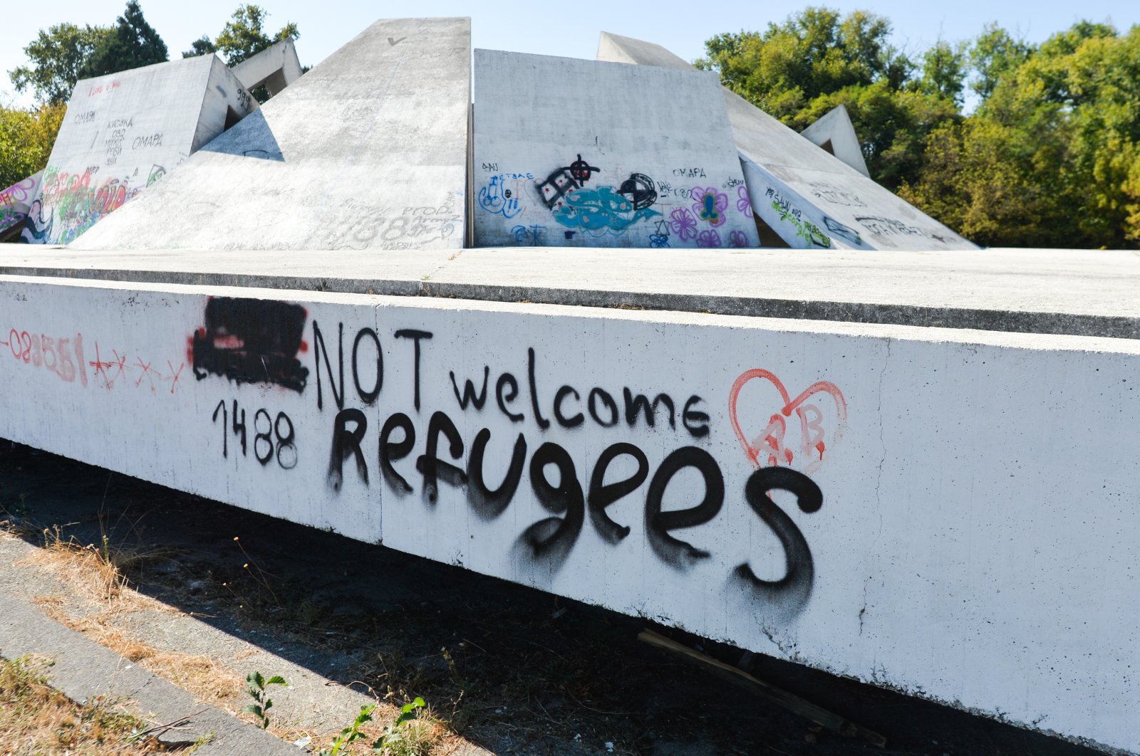 A graffiti reading &quot;NOT Welcome Refugees&quot; is seen on a wall at the Memorial Complex Hillock of Fraternity in &quot;Relaxation and Culture&quot; Park, in Plovdiv, Bulgaria, Oct. 2, 2020. (Reuters Photo)