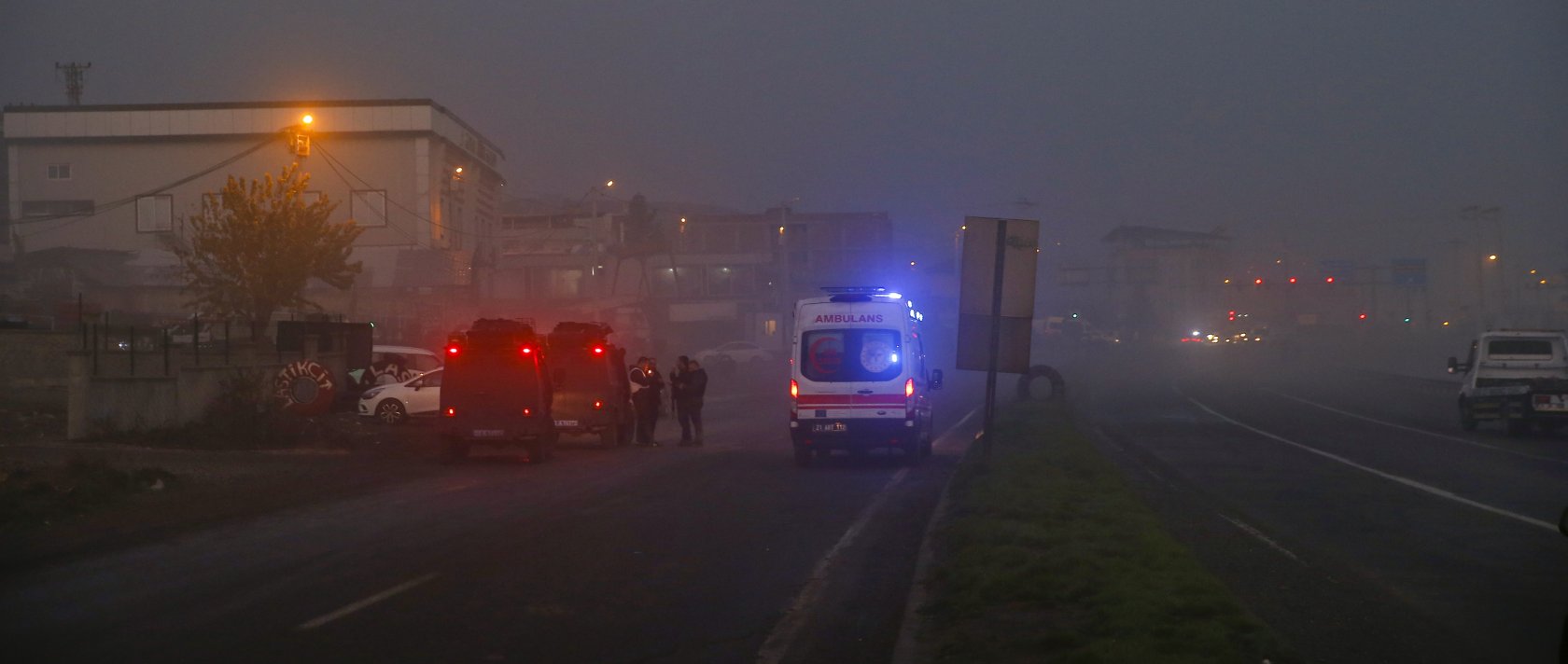 Medical teams and police personnel are deployed on a highway in Türkiye's southeastern Diyarbakır province after a car bomb explosion wound eight police officers, Dec. 16, 2022. (AA Photo)