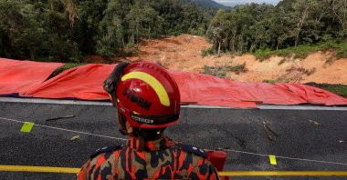 A rescue crew member checks the landslide area during a rescue and evacuation operation following a landslide at a campsite in Batang Kali, Selangor, Malaysia, Dec. 17, 2022. (Reuters Photo)