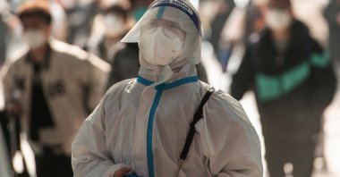A passenger wearing personal protective equipment arrives at Hankou Railway Station in Wuhan in central Hubei province, China, Dec. 10, 2022. (AFP Photo)