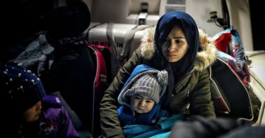 A woman and a child hug each other on a Turkish Coast Guard Command boat after being rescued in the Aegean Sea on Dec. 16, 2022. (Photo by Uğur Yıldırım)