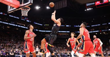 Phoenix Suns' Devin Booker (C) attempts a shot during an NBA game, Phoenix, Arizona, U.S., Dec. 17, 2022. (AFP Photo)