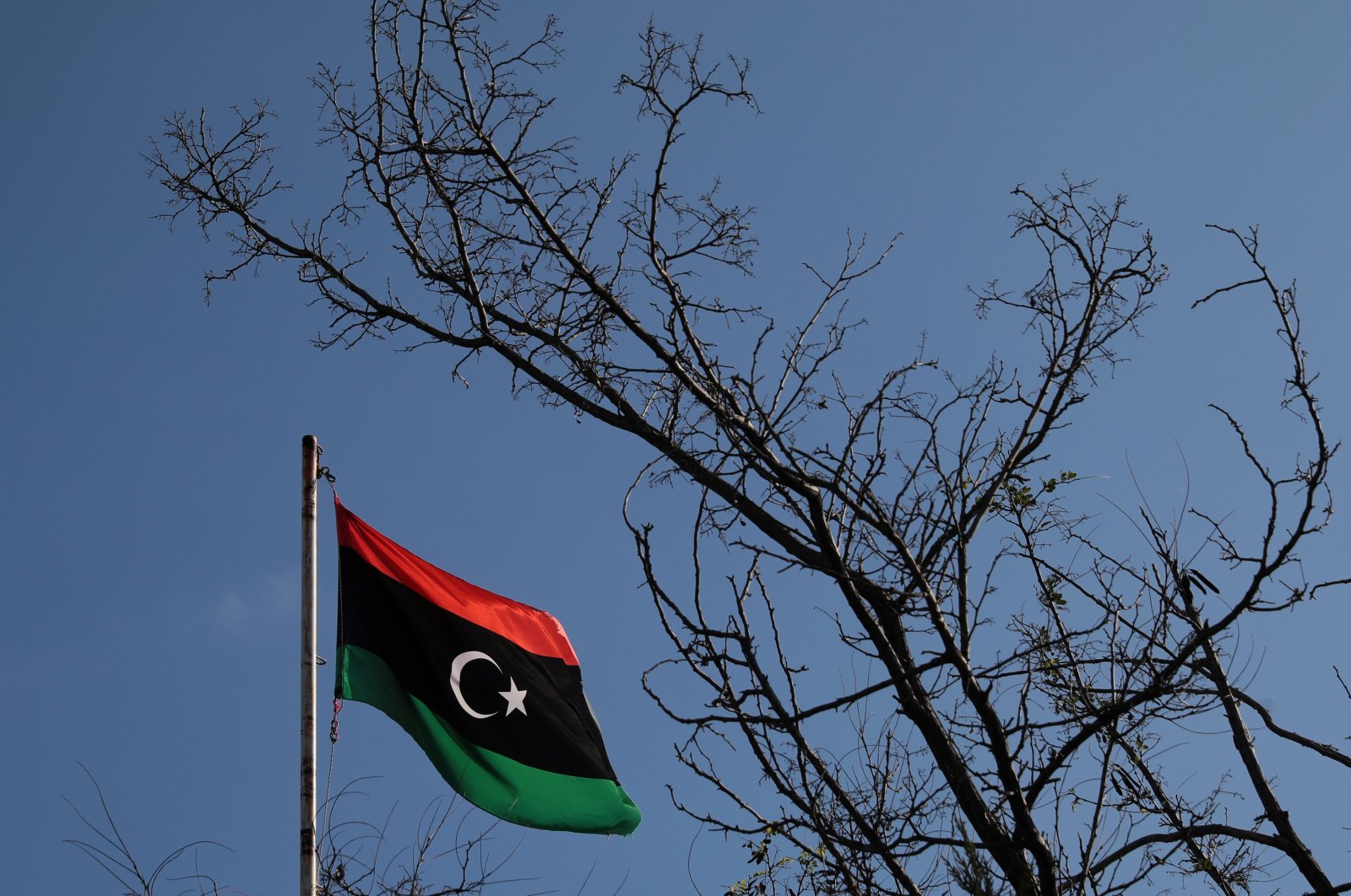 A Libyan flag flutters atop the Libyan Consulate in Athens, Greece, Dec. 6, 2019. (Reuters Photo)