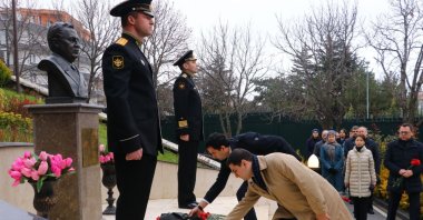 People lay flowers in front of a bust of Andrei Karlov, in the capital Ankara, Türkiye, Dec. 19, 2022. (DHA Photo)