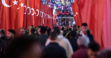 People seen walking with the nostalgic tram on Istiklal Street, Istanbul, Türkiye, Nov. 16, 2022. (Reuters Photo)