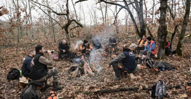 A group of lumberjacks take a rest around a woodfire in a forest near Grevena, northen Greece, Dec. 8, 2022. (AFP Photo)