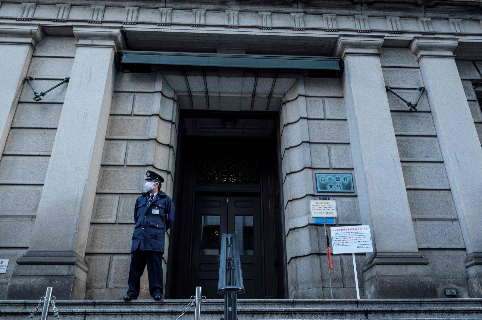 A member of security stands at an entrance to the Bank of Japan (BOJ) headquarters complex in Tokyo, Japan, Dec. 20, 2022. (AFP Photo)