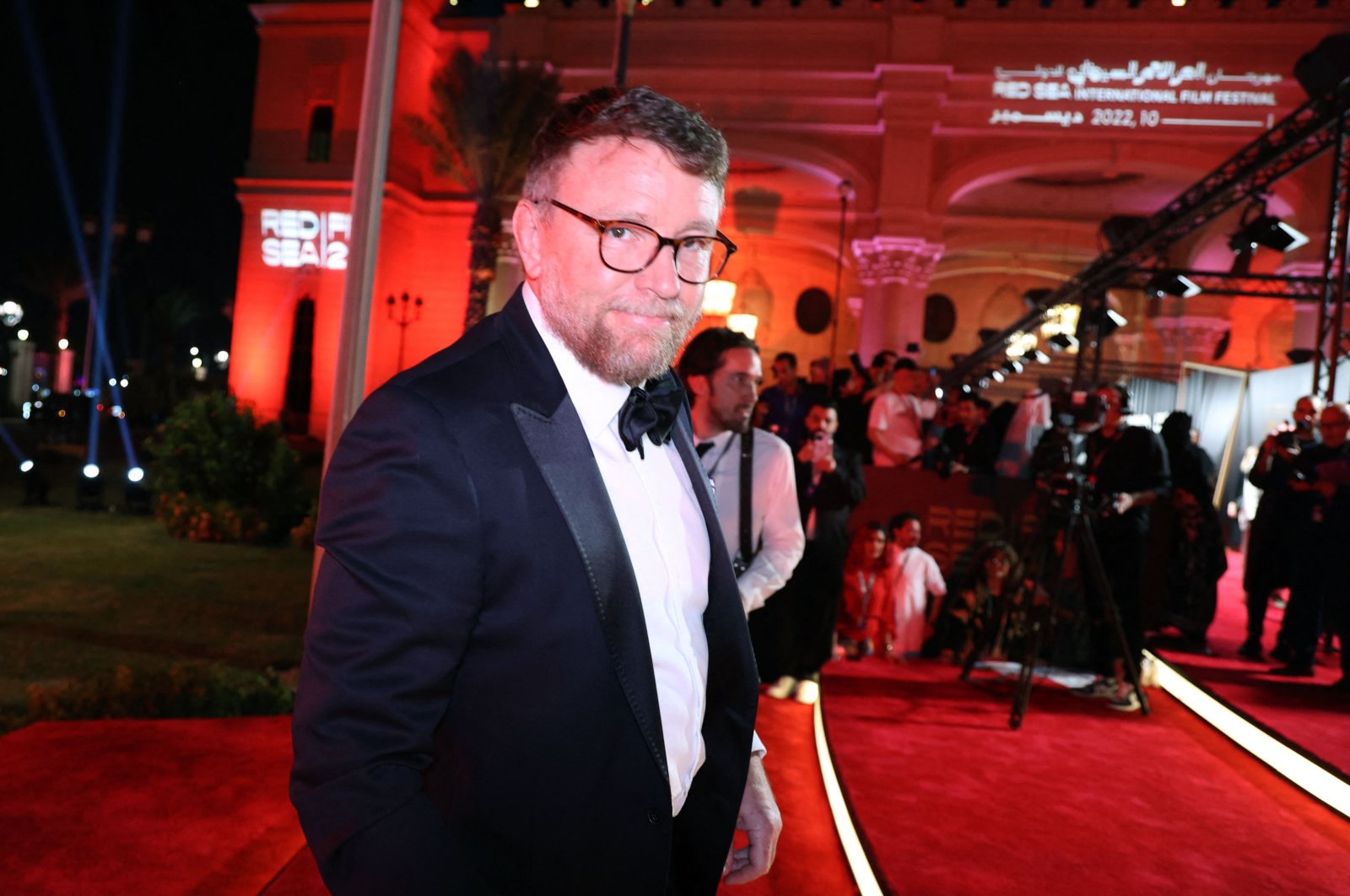 A handout picture released by the Red Sea International Film Festival (RSFF) shows British director Guy Ritchie arriving on the red carpet at the opening ceremony in Saudi Arabia&#039;s Red Sea coastal city of Jeddah, Dec. 1, 2022. (AFP Photo)