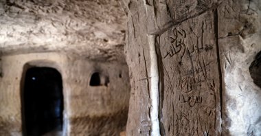Inscriptions left by pilgrims are seen on the wall of a cave that, according to the Israel Antiquities Authority, is the 2,000-year-old burial cave of Jesus' midwife, Salome, in the Lachish Forest, Israel, Dec. 20, 2022. (Reuters Photo)
