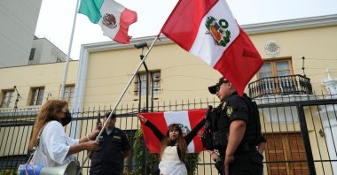 Demonstrators stand outside the Mexican embassy in Lima, Peru, Dec. 20, 2022. (Reuters Photo)