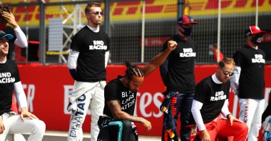 Great Britain's Lewis Hamilton and Mercedes GP takes a knee on the grid in support of the Black Lives Matter movement prior to the F1 70th Anniversary Grand Prix at Silverstone, Northampton, England, Aug. 9, 2020. (Getty Images Photo)