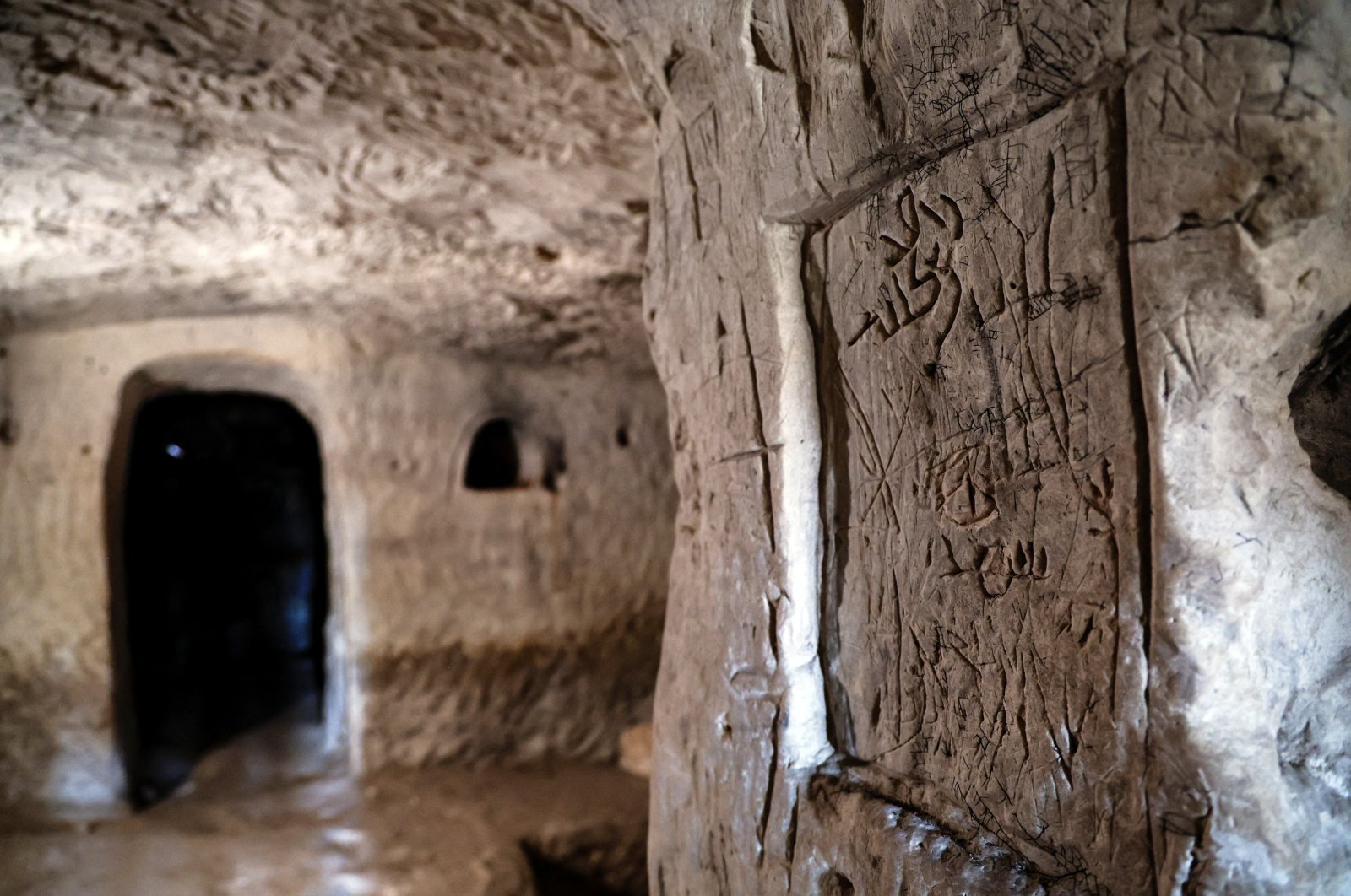 Inscriptions left by pilgrims are seen on the wall of a cave that, according to the Israel Antiquities Authority, is the 2,000-year-old burial cave of Jesus&#039; midwife, Salome, in the Lachish Forest, Israel, Dec. 20, 2022. (Reuters Photo)