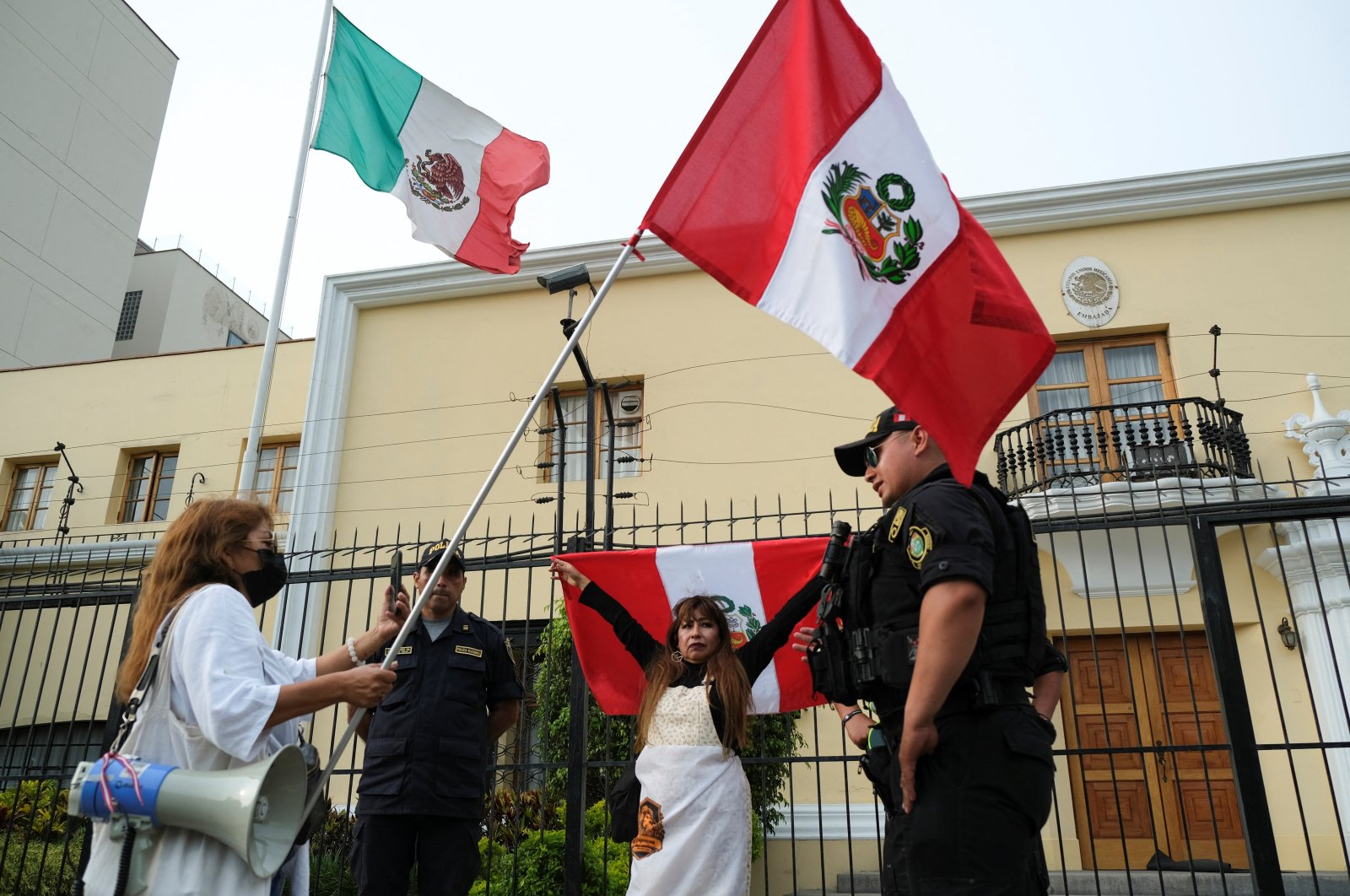 Demonstrators stand outside the Mexican embassy in Lima, Peru, Dec. 20, 2022. (Reuters Photo)