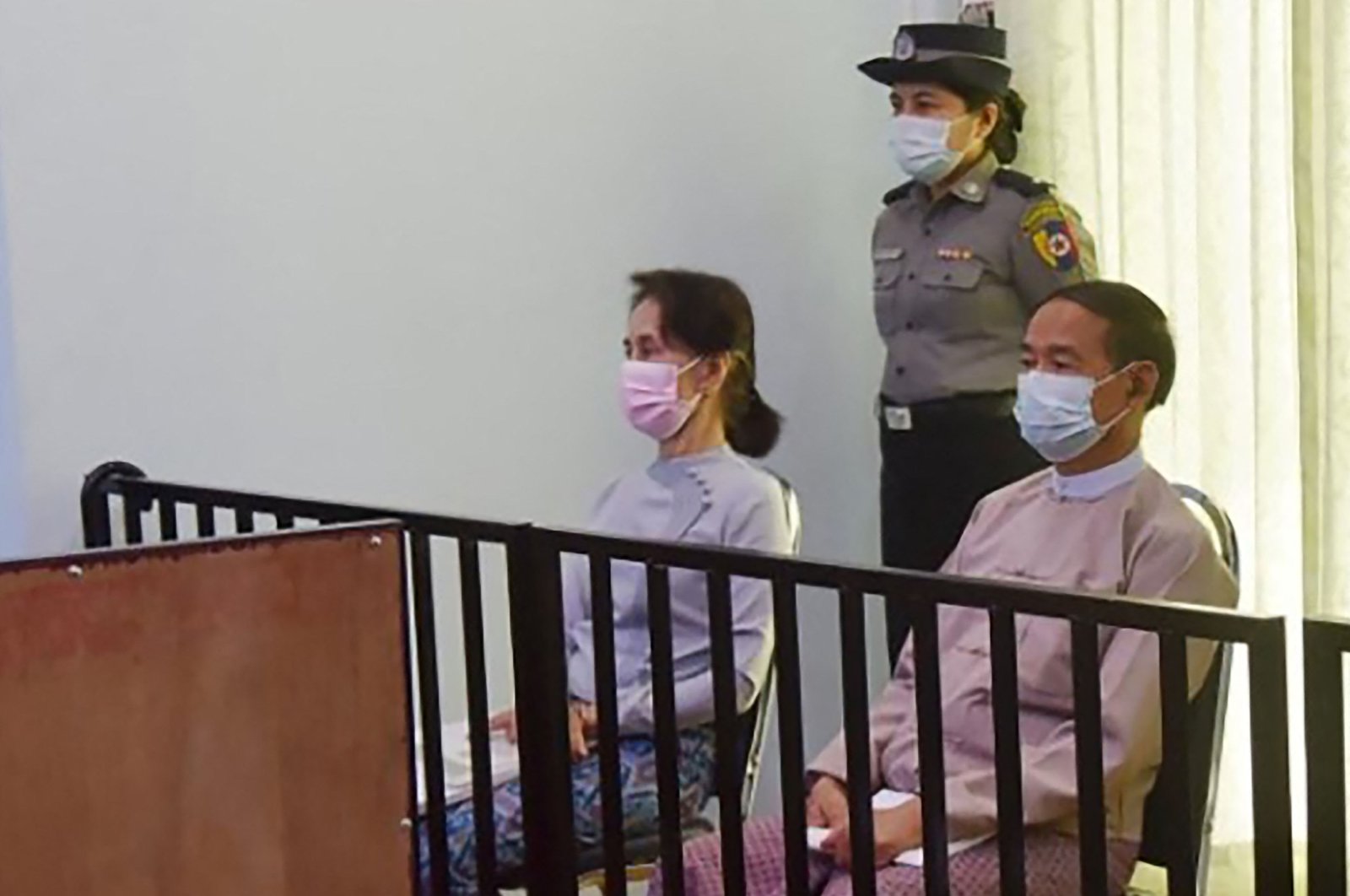 A file handout photo, taken on May 24, 2021 and released by Myanmar&#039;s Ministry of Information on May 26, shows detained civilian leader Aung San Suu Kyi (L) and detained president Win Myint (R) during their first court appearance in Naypyidaw, since the military detained them in a coup. (Myanmar&#039;s Ministry of Information Photo via AFP)