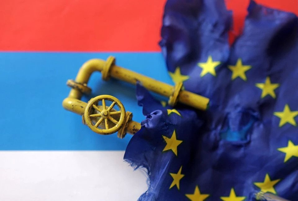 A model of a natural gas pipeline and a torn European Union flag are placed on a Russian flag in this illustration, Sept. 7, 2022. (Reuters Illustration)