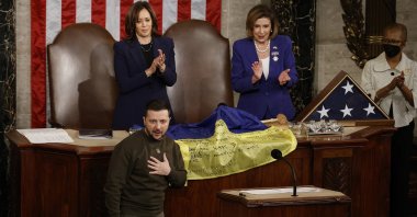 Ukraine President Volodymyr Zelenskyy (L) thanks members of Congress after presenting a flag signed by Ukrainian troops to U.S. House Speaker Nancy Pelosi (2nd R) and Vice President Kamala Harris (C) during a joint meeting of Congress, Washington, D.C., U.S., Dec. 21, 2022. (AFP Photo)