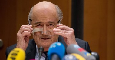 Former FIFA President Joseph S. Blatter adjusts his glasses during a press conference in reaction to his banishment for eight years by the FIFA ethics committee at FIFA's former headquarters at Sonnenberg, Zurich, Switzerland, Dec. 21, 2015. (Getty Images Photo)