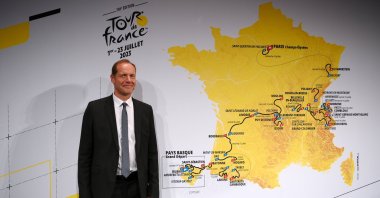 Christian Prudhomme, director of the Tour de France, stands in front of the map showing the route of the men's race during the 110th Tour de France 2023 and 2nd Tour de France Femmes 2023. Paris, France, Oct. 27, 2022. (Getty Images Photo)