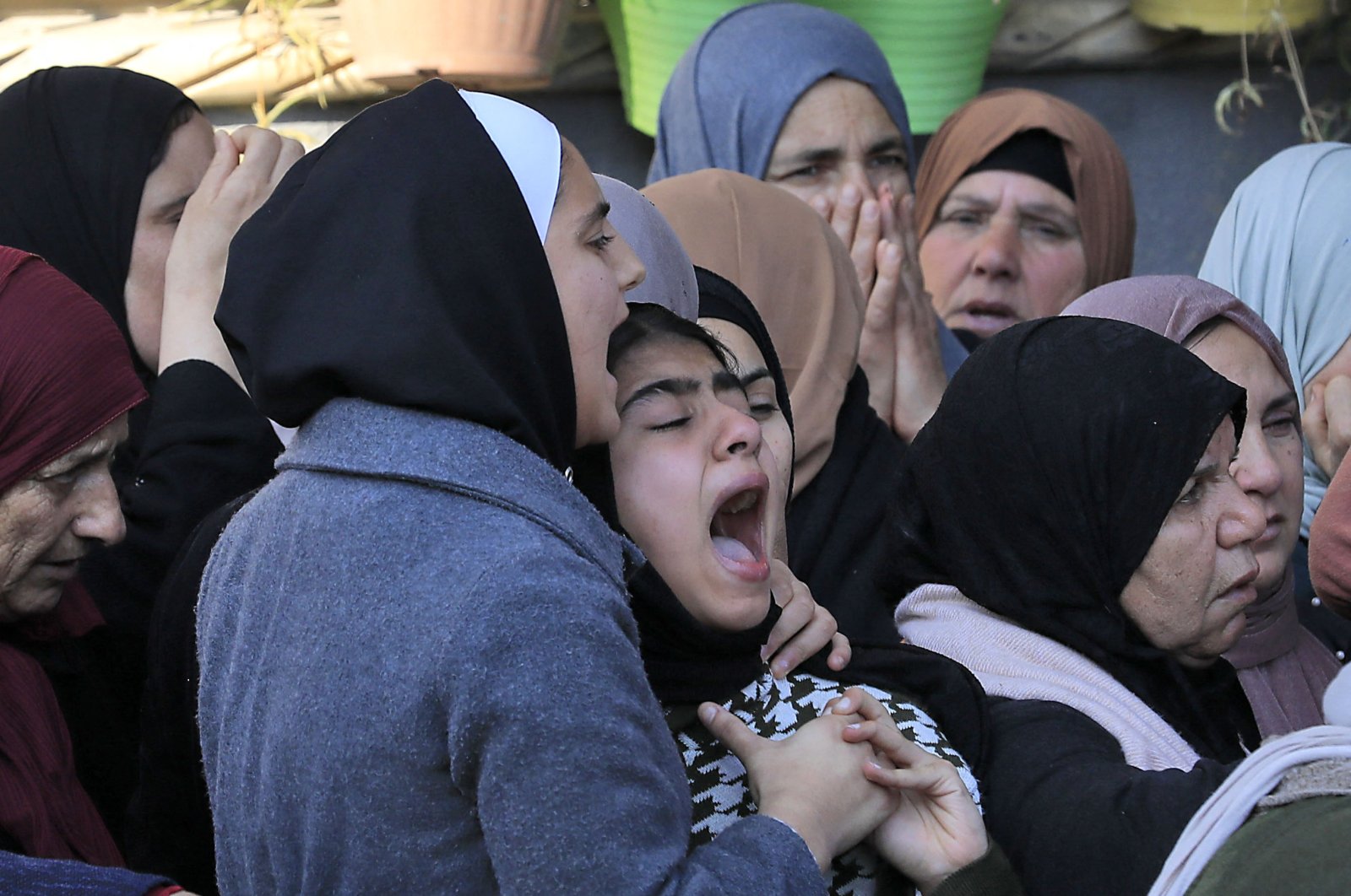 Relatives mourn during the funeral of Ahmed Atef Daraghmeh, 23, killed during clashes with Israeli forces in occupied West Bank, Palestine, Dec. 22, 2022. (AFP Photo)