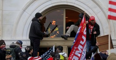 A mob of supporters of then-U.S. President Donald Trump climb through a window they broke as they storm the U.S. Capitol Building. Washington, U.S., Jan. 6, 2021. (Reuters Photo)
