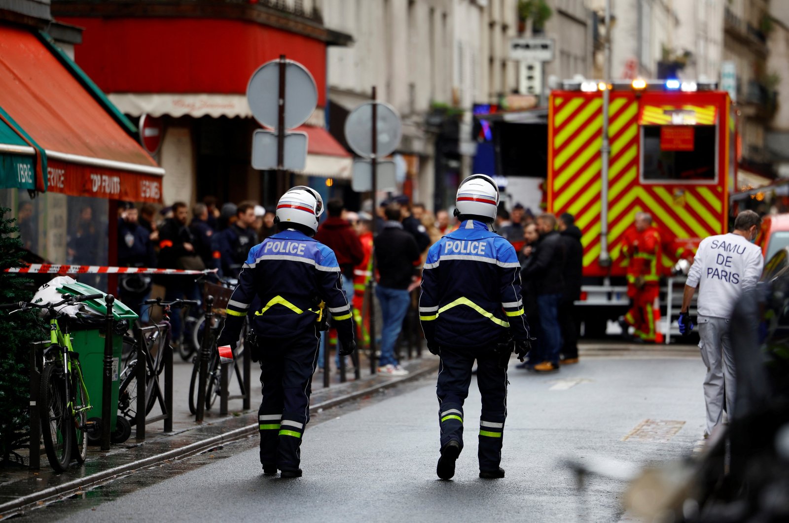 French police and firefighters secure a street after gunshots were fired killing two people and injuring several in a central district of Paris, France, Dec. 23, 2022. (Reuters Photo)