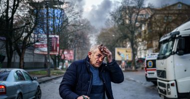 An injured man stands on a street after Russian shelling to Ukrainian city of Kherson, Ukraine, Dec. 24, 2022. (AFP Photo)