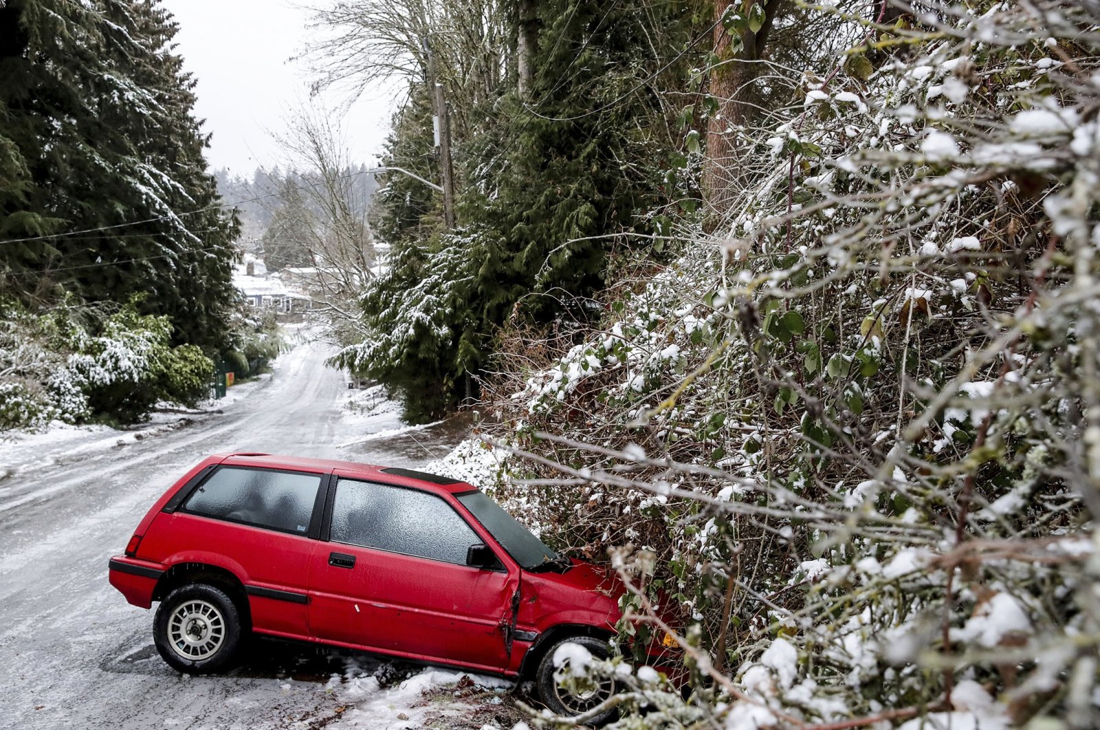 A car is left on the side of the road due to dangerous road conditions, in Seattle, U.S., Dec. 23, 2022. (AP Photo)