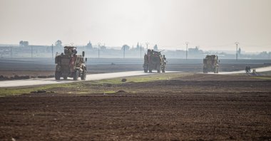 U.S. military vehicles patrol the countryside near the town of Qamishli, Syria, Dec. 4, 2022. (AP Photo)