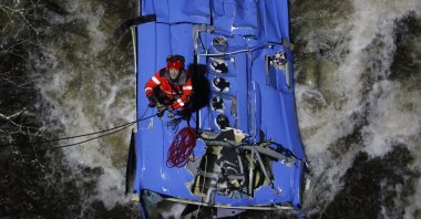 A fireman works to rescue victims of a bus that fell into Lerez river in Cerdedo-Cotobade, Pontevedra, Galicia, Spain, Dec. 25, 2022. (EPA Photo)
