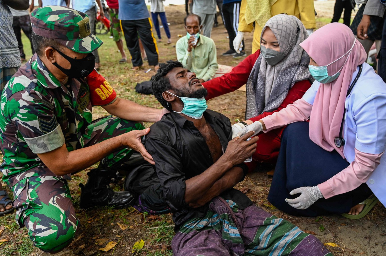 Health workers check a Rohingya refugee who was feeling sick after his arrival by boat in Krueng Raya, Indonesia, Dec. 25, 2022. (AFP Photo)