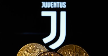 A representation of cryptocurrency is seen with the Juventus football club logo displayed in the background in this illustration photo, Krakow, Poland, Dec. 10, 2021. (Getty Images Photo)