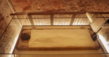 A tourist films Tutankhamun&#039;s mummy in his tomb chamber in the Valley of the Kings in Luxor, Egypt, Nov. 4, 2022. (AP Photo)