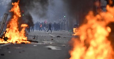 PKK terror group supporters face riot police as clashes erupt, at The Place de la Republique, in Paris, France, Dec. 24, 2022. (AFP Photo)