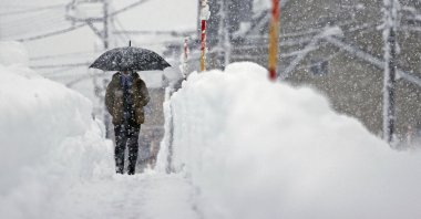 A man makes his way in the heavy snow in Uonuma, Niigata Prefecture, Japan, Dec. 20, 2022. (Reuters Photo)