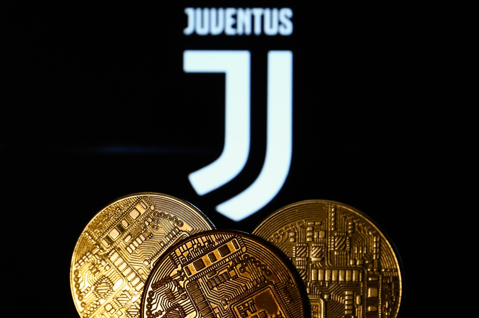 A representation of cryptocurrency is seen with the Juventus football club logo displayed in the background in this illustration photo, Krakow, Poland, Dec. 10, 2021. (Getty Images Photo)