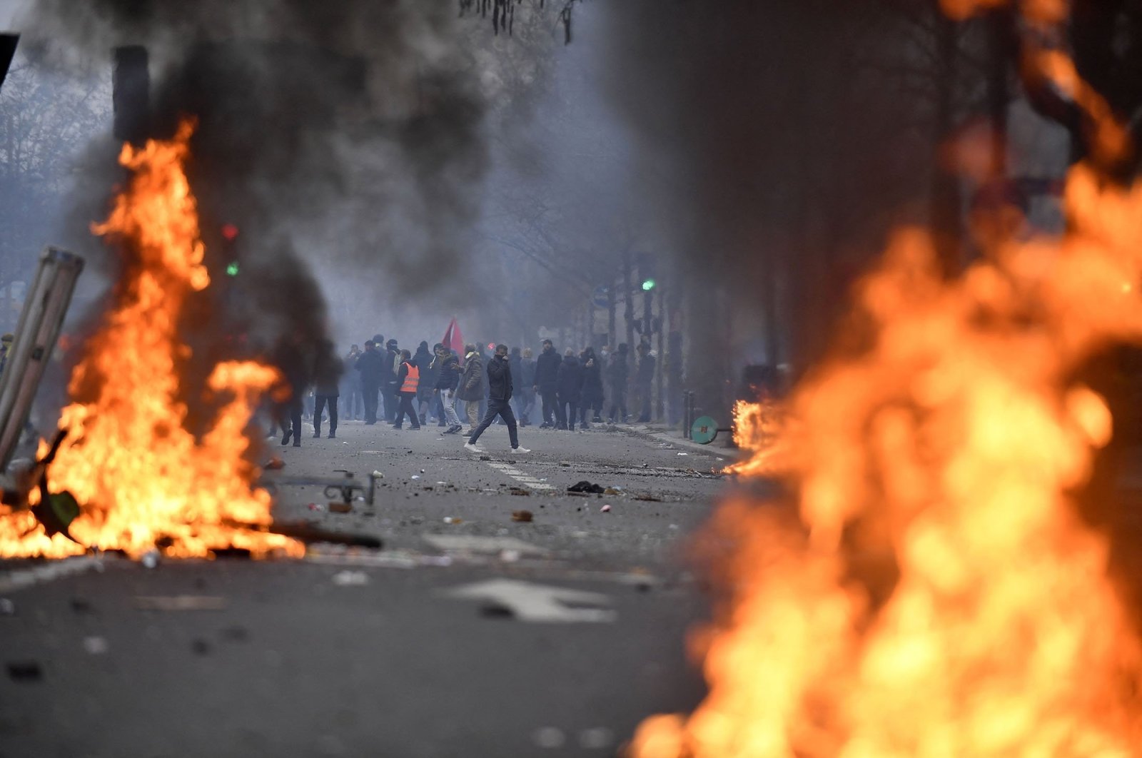 PKK terror group supporters face riot police as clashes erupt, at The Place de la Republique, in Paris, France, Dec. 24, 2022. (AFP Photo)