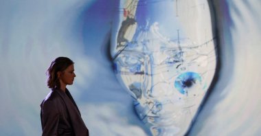 A model presents at the first designer-led AI fashion collection that was assisted by AiDA, during "Fashion X AI : Call For Young Talents 2022" fashion show in Hong Kong, China, Dec. 19, 2022. (Reuters Photo)