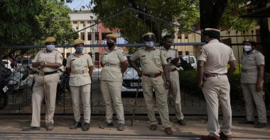 Police officers stand guard at a gate of the Mahatma Gandhi Memorial college in Udupi, Karnataka state, India, Feb. 24, 2022. (AP File Photo)