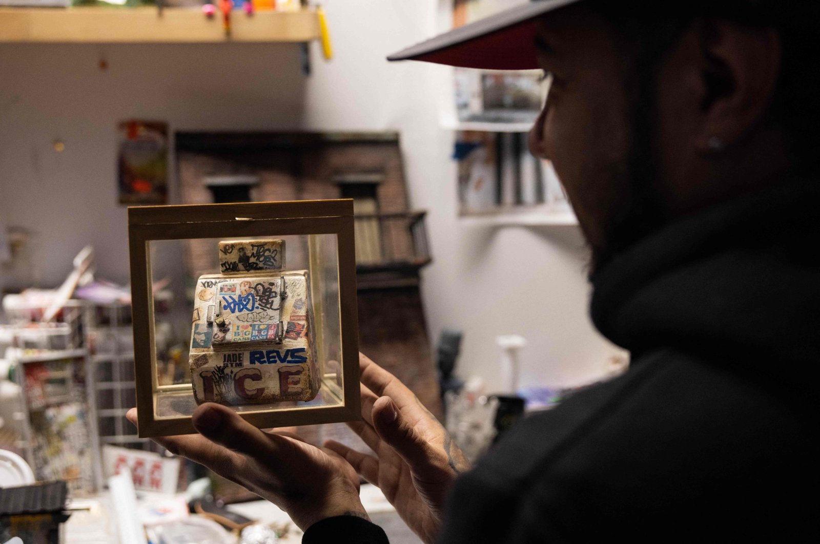 Danny Cortes, a street miniature artist, shows his first miniature of an ice box at his studio in the Brooklyn borough of New York City, U.S., Dec. 19, 2022. (AFP Photo)