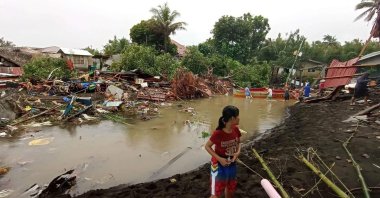 Residents survey damages caused by heavy rain and floods in Oroquieta City, Misamis Occidental, the Philippines, Dec. 28, 2022. (AFP Photo)