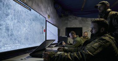 Ukrainian soldiers watch drone feeds from an underground command center in Bakhmut, Donetsk region, Ukraine, Dec. 25, 2022. (AP Photo)
