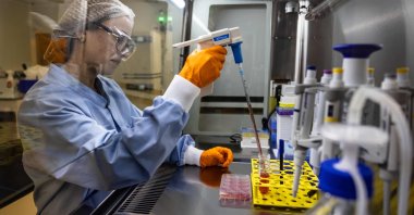 An operator performs a manipulation under controlled atmosphere in an Urgo laboratory dedicated to the Genesis project at the Urgo site in Chenove, France, Dec. 16, 2022. (AFP Photo)