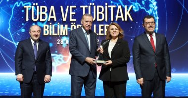 President Recep Tayyip Erdoğan hands an award to professor Özge Çevik, one of the recipients, in the capital Ankara, Türkiye, Dec. 28, 2022. (AA Photo)